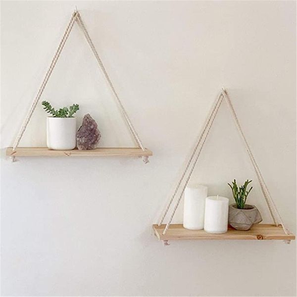 Antique wooden swing with rope for hanging plants, ideal for indoor and outdoor decor