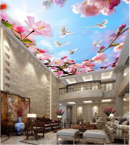 Beautiful flowering branches against a blue sky with white clouds, a modern ceiling mural wallpaper for living rooms