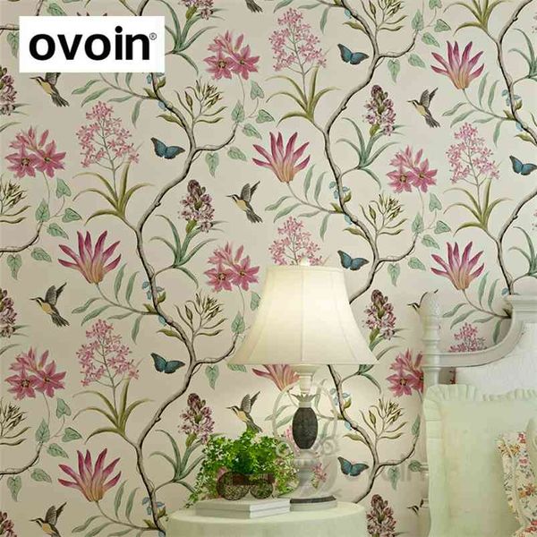Chinoiserie-inspired bedroom wallpaper featuring modern vintage pink floral designs with blue tropical butterflies, birds, and flowers
