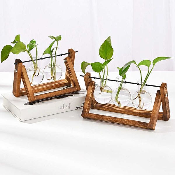 Creative Hydroponic Plant Bonsai Wooden Frame Glass Vase Modern Living Room Desktop Decorations Flower Pots 210624

Modern wooden-framed glass vase for hydroponic bonsai plants, ideal as contempora...