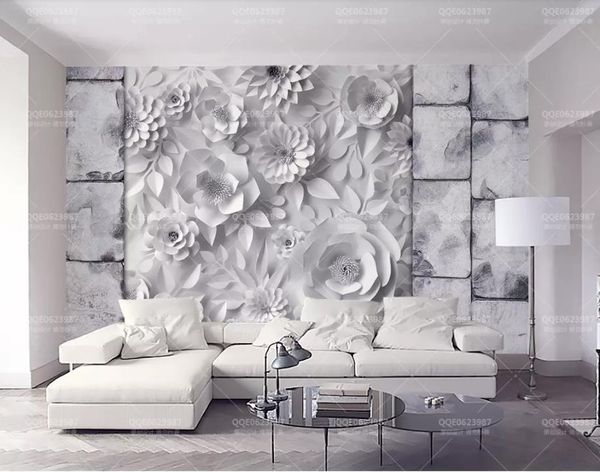 Custom 3D mural wallpaper featuring a stone brick wall design with origami flowers, perfect for TV backgrounds in living rooms and bedrooms as home decor