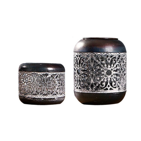 Cylindrical Chinese-style lantern candle holder with hollow vintage black metal design, ideal for weddings, spas, Reiki, and aromatherapy tea lights
