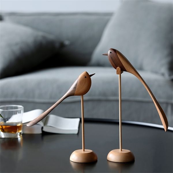 Danish wood-carved jewelry and Nordic-style home decor featuring bird motifs in puppetry
