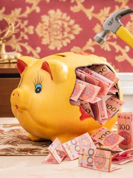 Decorative ceramic piggy bank for storing coins and bills, designed as a hidden safe in living spaces