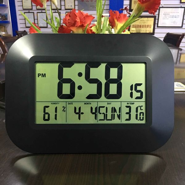 Decorative digital wall clock with calendar, thermometer, hygrometer, and radio-controlled time display