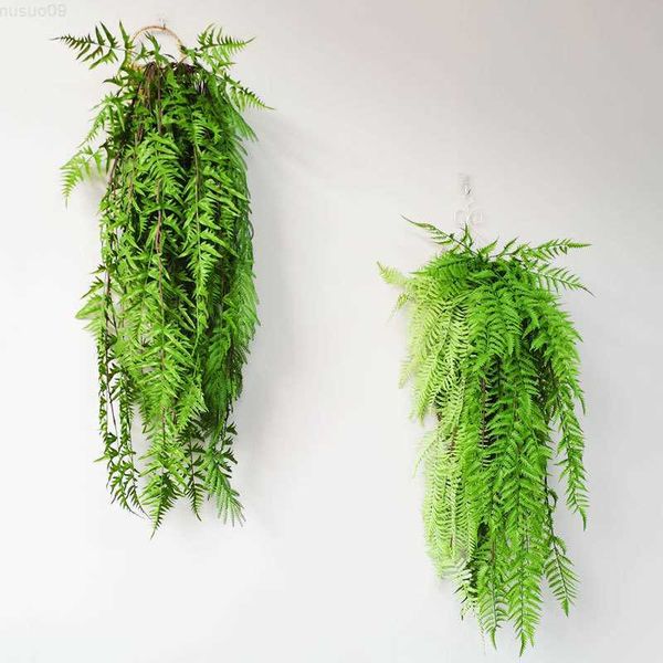 Decorative figurines and artificial hanging plants including fake Boston ferns, vine plastic leaves, and Christmas wall decor for home holiday displays