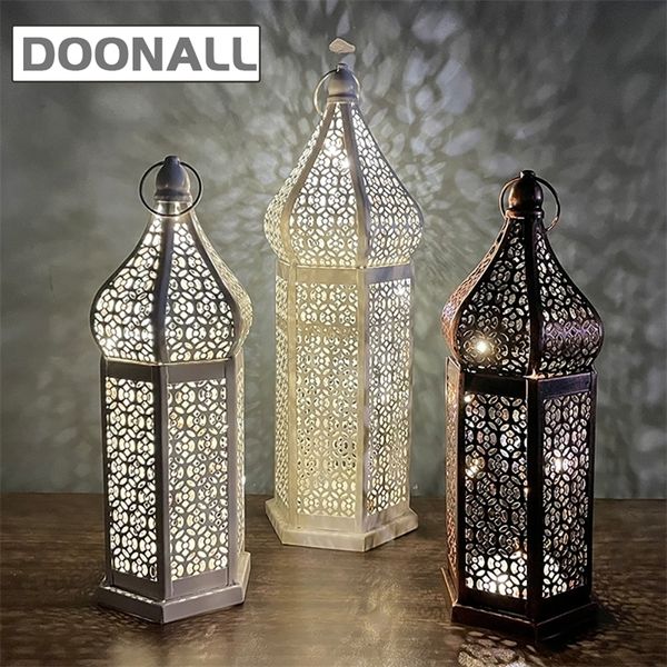 Hollow retro Moroccan boho lantern with carved design, cordless portable desk lamp featuring a romantic metal cage for ambient home lighting