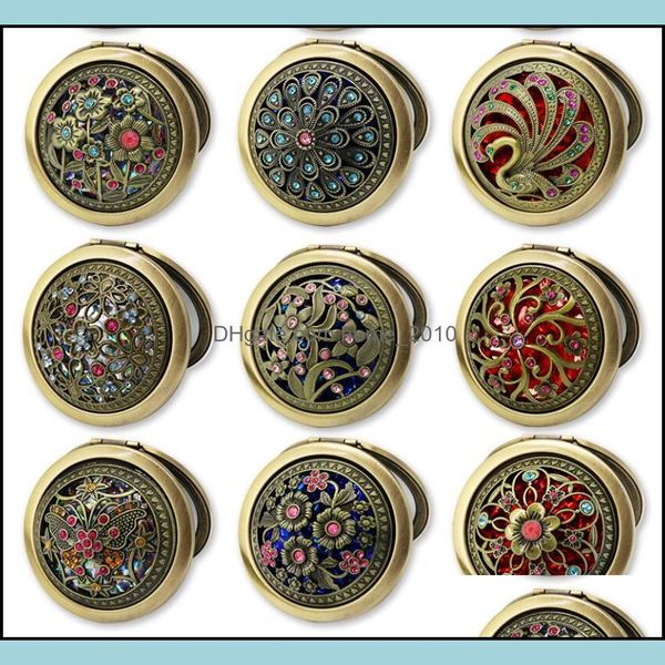 Mini vintage-style stainless steel cosmetic compact mirrors featuring butterfly, flower, and peacock designs