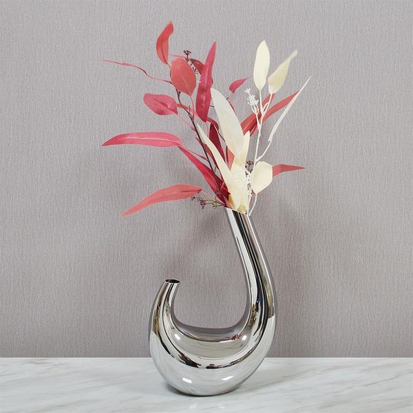 Nordic luxury vases for modern minimalist bathrooms, featuring sleek silver plant pots and elegant shelf decor