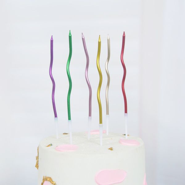 Wholesale birthday party supplies featuring creative spiral candles in gold, silver, pink, and red with gold-plated finish, 6 pieces per box
